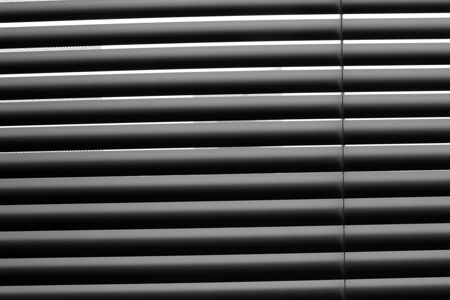 Photo of light streaming in through blinds by Chloe Atchue-Mamlet